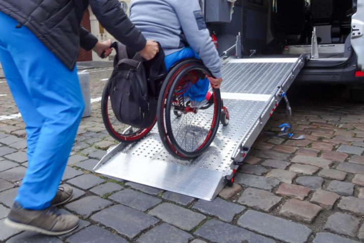 Man in wheelchair getting into van
