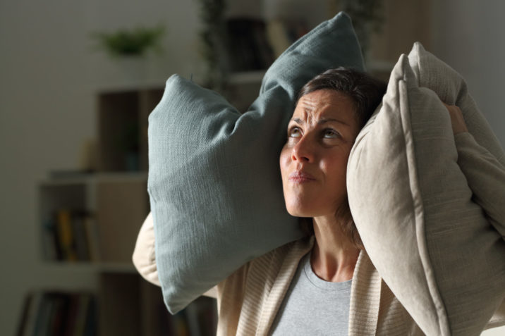 Woman guarding agaisnt noise