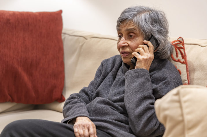 Worried senior talking on phone