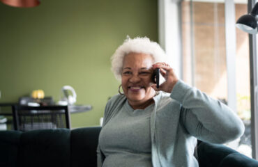 Senior woman talking on the phone at home