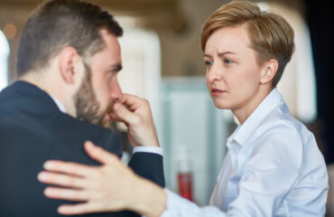 Helpful colleague comforting frustrated businessman in trouble